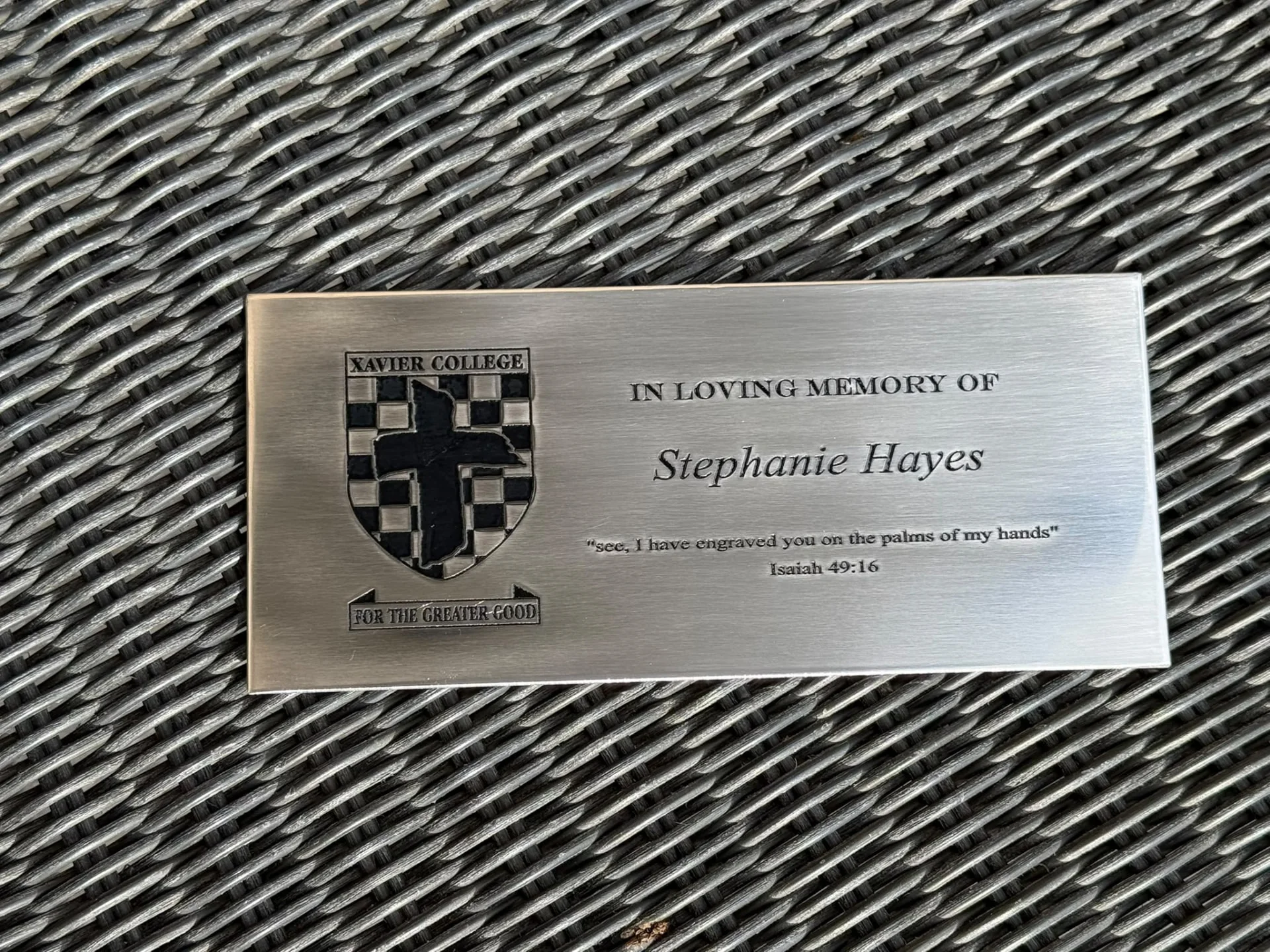 Brushed metal memorial plaque with an engraved crest and remembrance wording