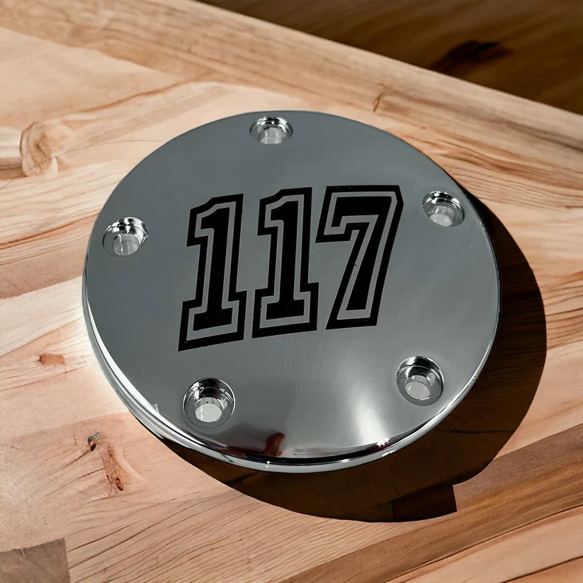 Polished motorcycle timing cover custom engraved with the number 117