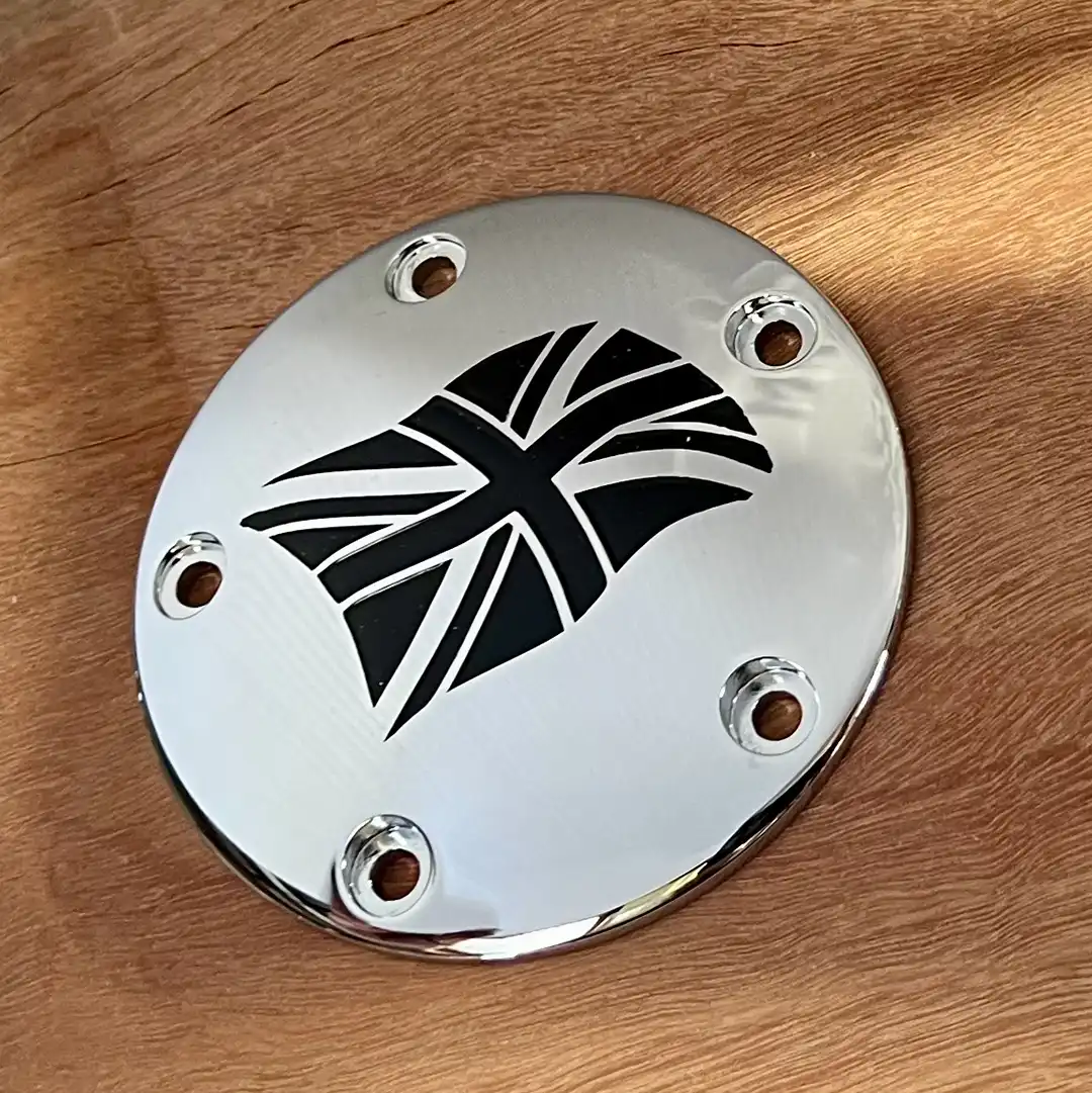 Polished twin cam cover engraved with a black geometric cross design