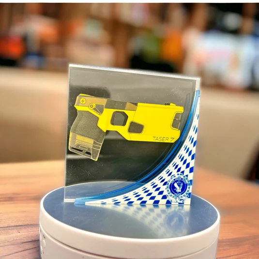 Custom presentation piece featuring a police Taser design and insignia