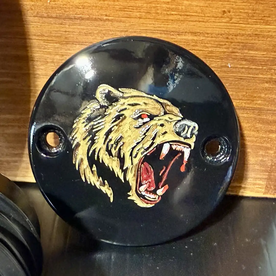 Black Harley-Davidson M8 timing cover with detailed bear engraving