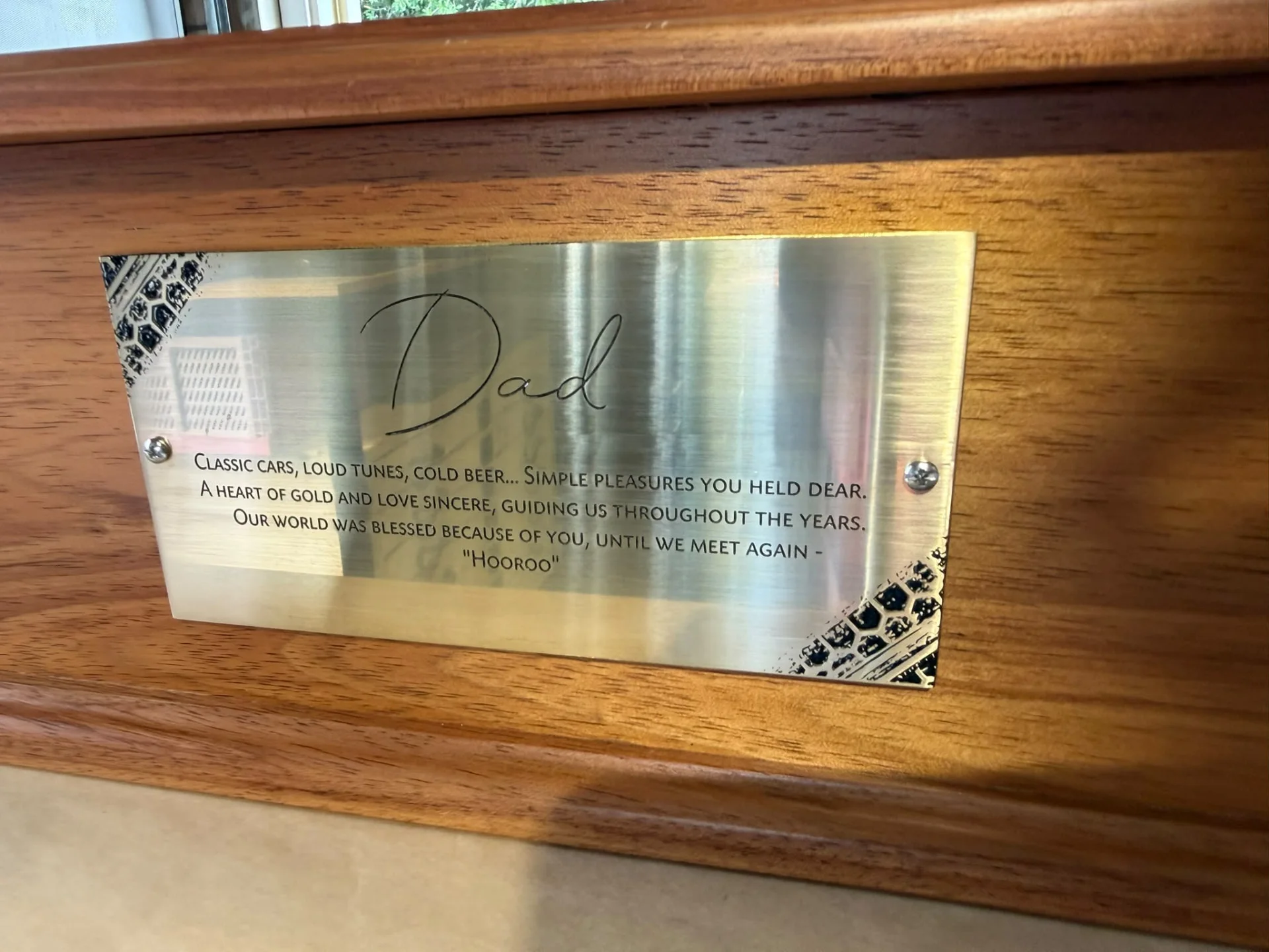 Brass memorial plaque mounted on a timber keepsake